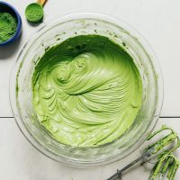 Bowl of bright green matcha frosting for a natural frosting recipe