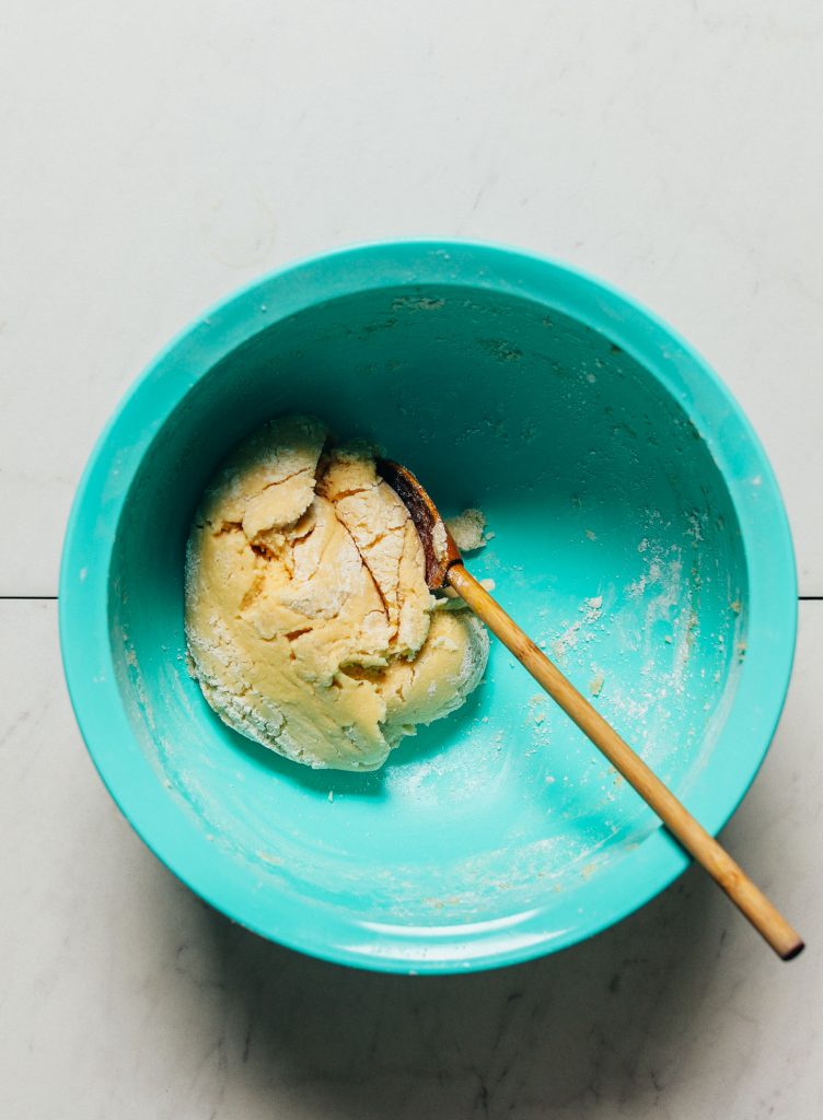 Wooden spoon in a bowl of Grain-Free Sugar Cookie Dough