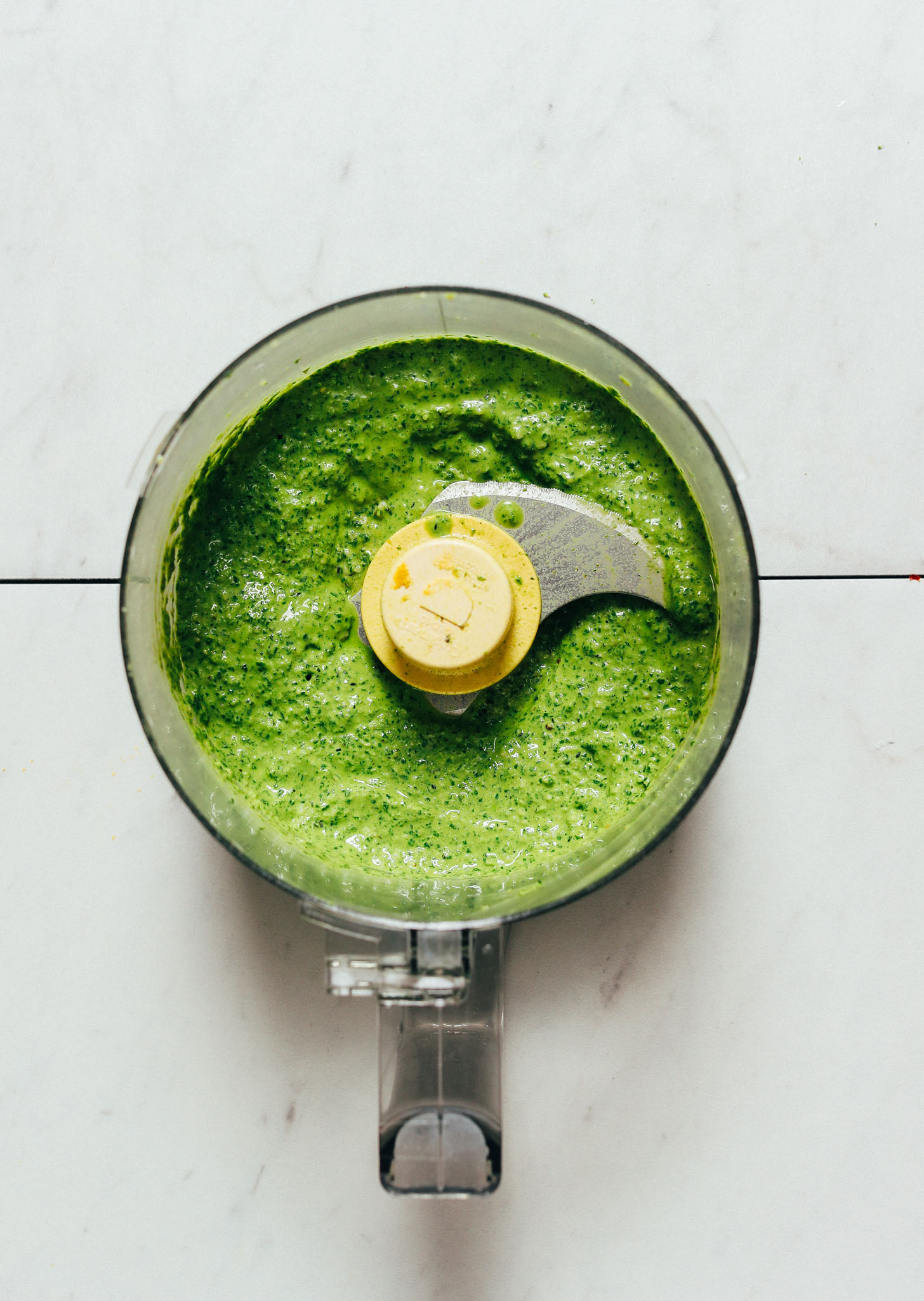 Food processor filled with homemade pesto for making Pesto Pasta Salad