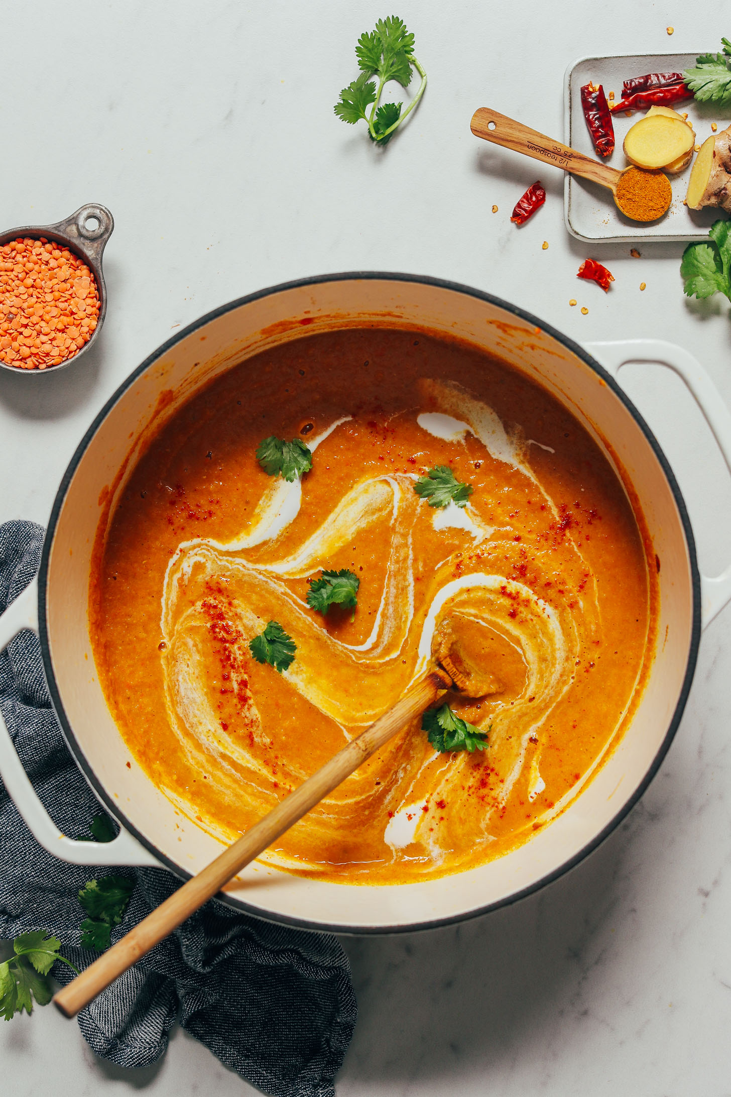 Pot of Curried Cauliflower Lentil Soup with a swirl of coconut milk