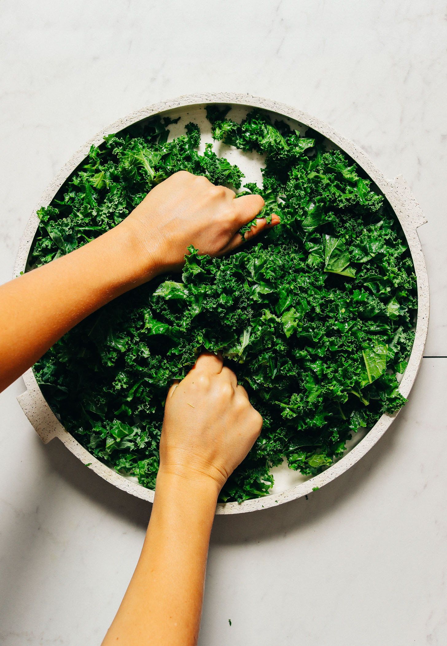 Massaging a platter of kale