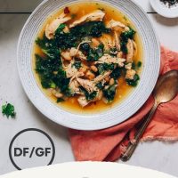 Bowl of our 1-Pot Chicken Soup recipe made with white beans and kale
