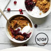 Bowl fo Cranberry Pumpkin Steel Cut Oats topped with coconut whipped cream