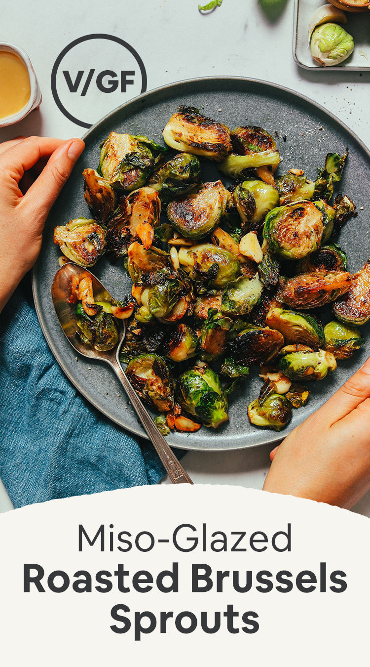 Holding a plate of Miso-Glazed Brussels Sprouts with recipe text below it