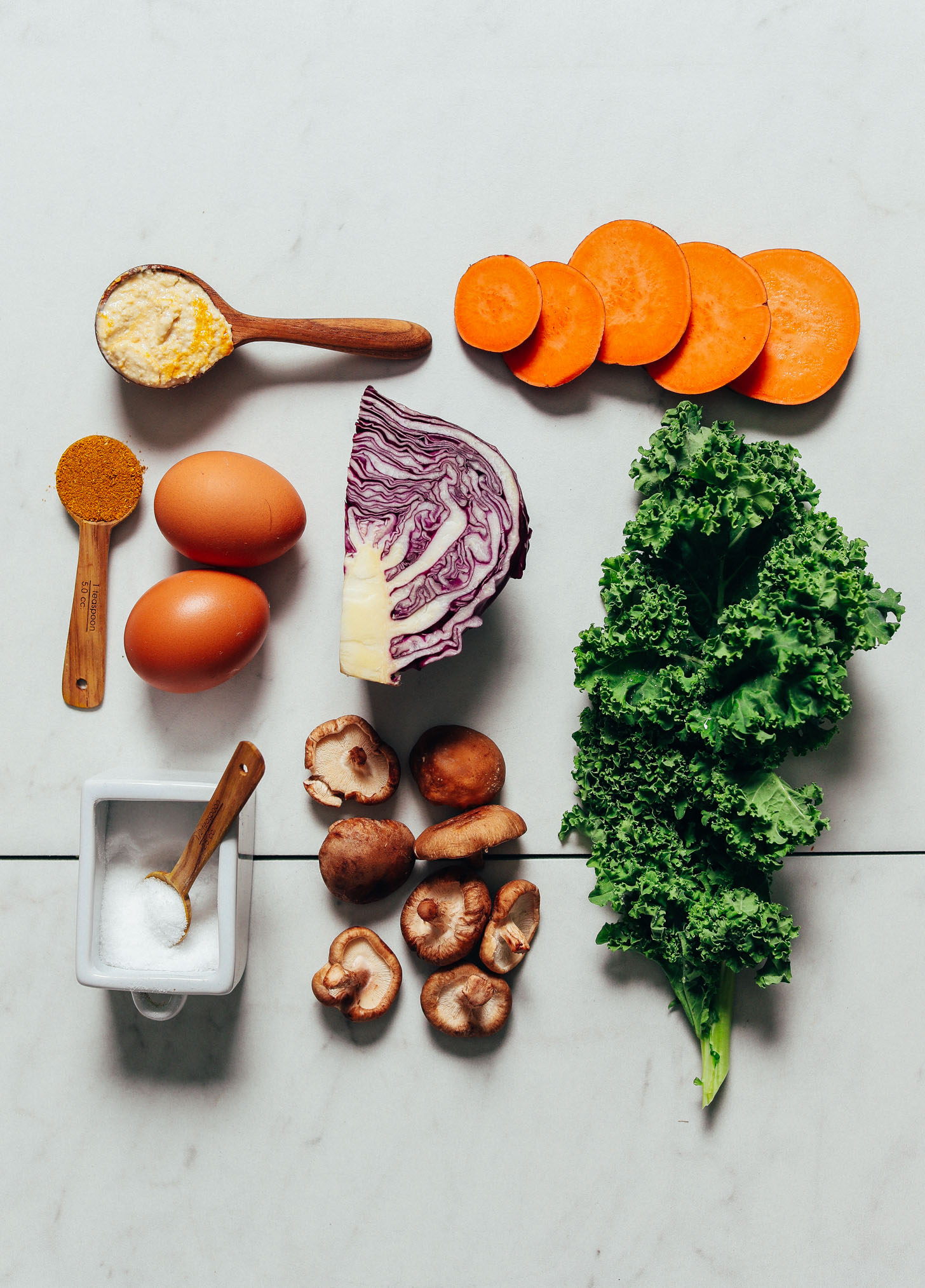 Cabbage, kale, mushrooms, sweet potato, eggs, and other ingredients for making Simple But Good Breakfast Bowls