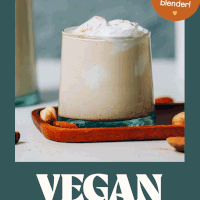 Glass of our Easy Vegan Eggnog recipe topped with coconut whipped cream