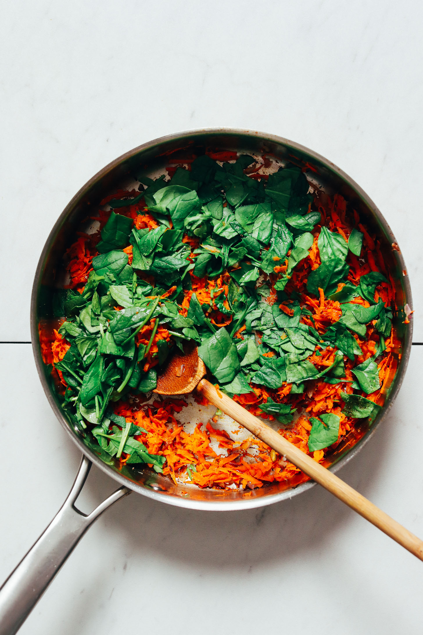 Skillet of sweet potato and spinach for making our Quinoa Sweet Potato Fritters recipe