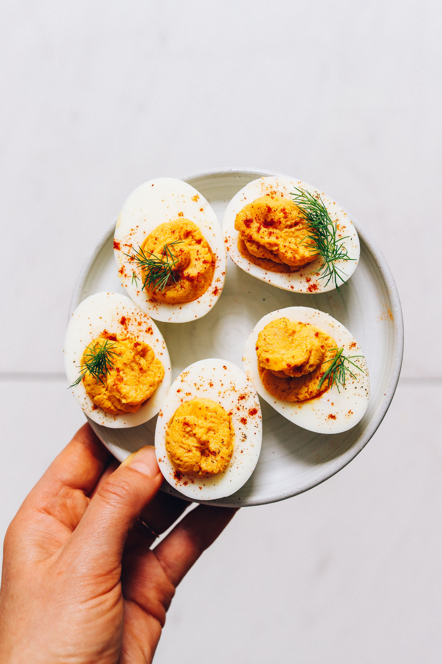 Plate of Mayo-Free Deviled Eggs topped with paprika and fresh dill