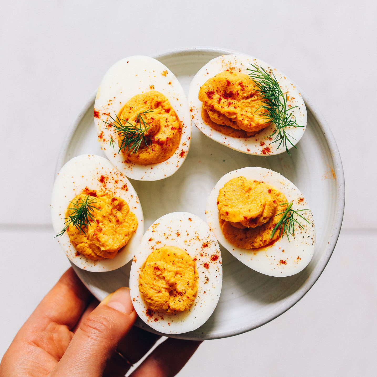 Plate of Mayo-Free Deviled Eggs seasoned with turmeric, honey, and other spices