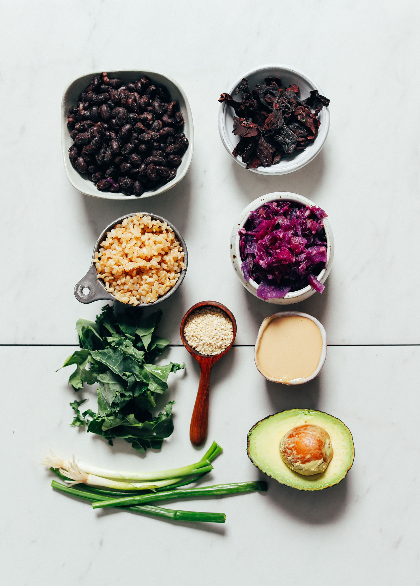 Black beans, seaweed, brown rice, sauerkraut, kale, and other ingredients for making our Black Bean Buddha Bowl recipe