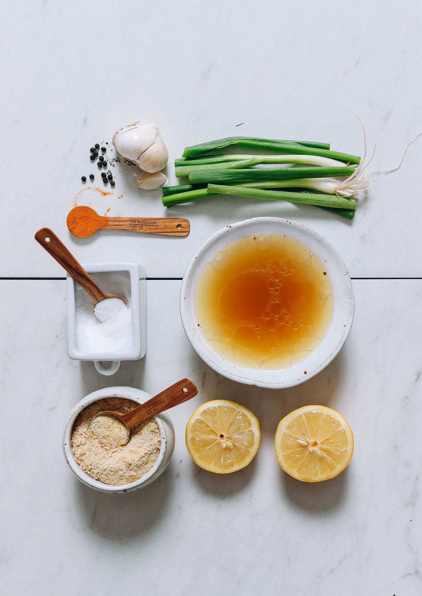 Bone broth, nutritional yeast, green onion, turmeric, and other ingredients for making our Nourishing Bone Broth Tonic recipe