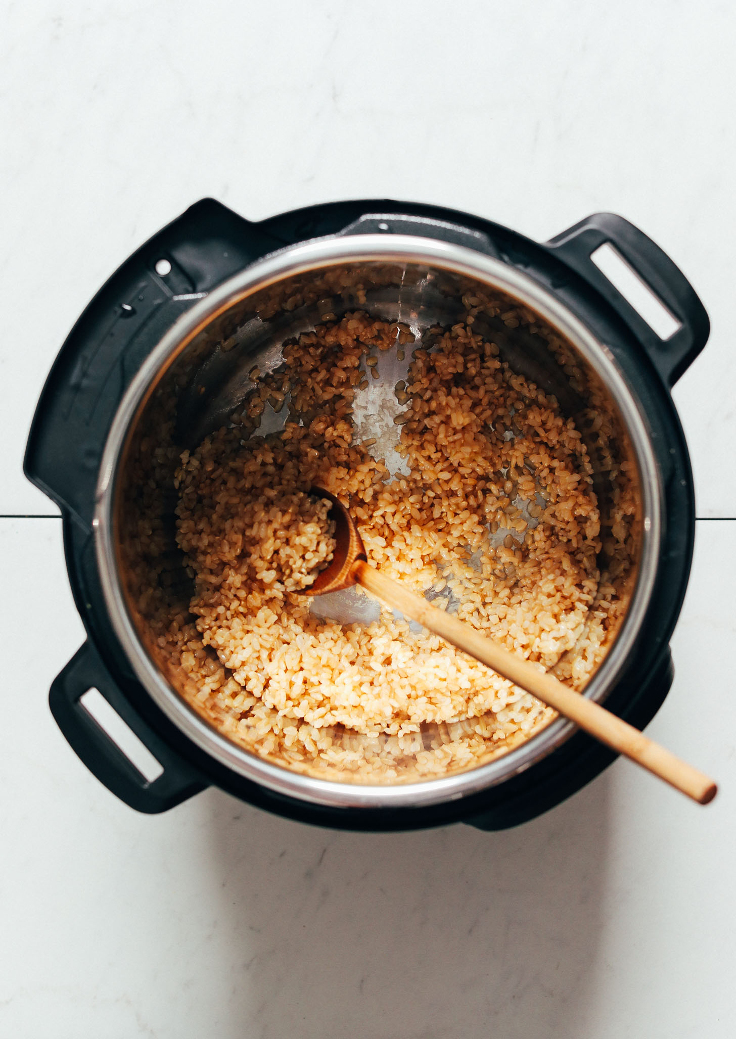 Wooden spoon and perfectly cooked brown rice in an Instant Pot