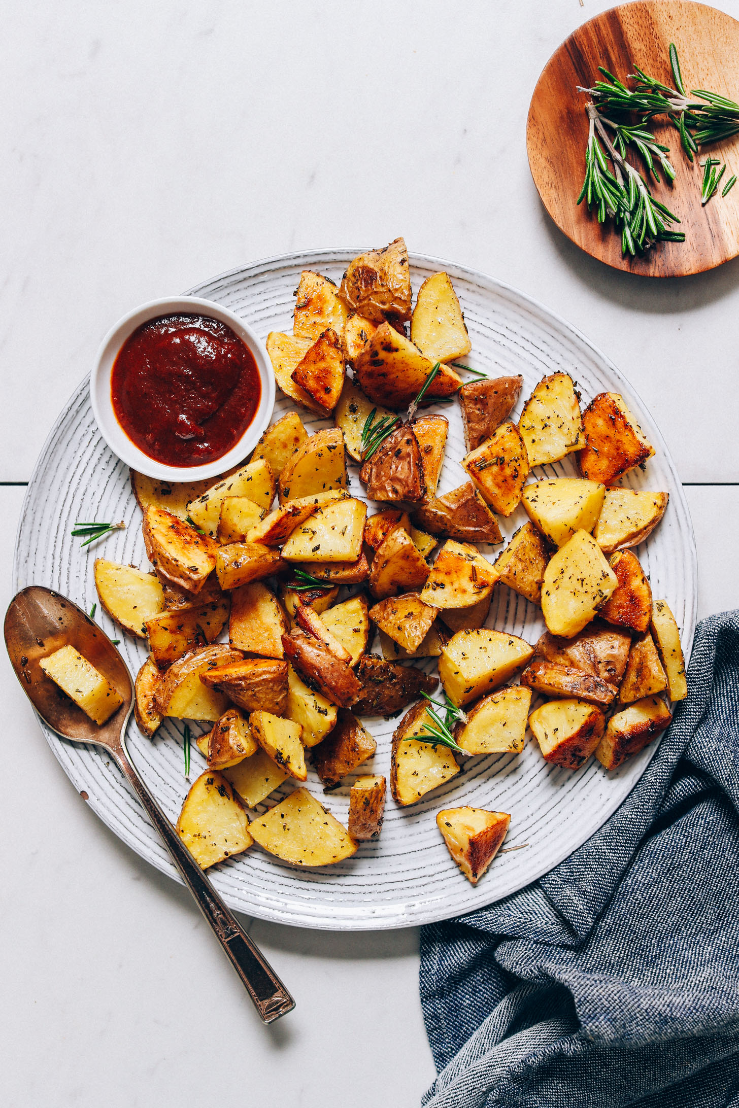 Large plate of Oven Roasted Potatoes with rosemary and ketchup