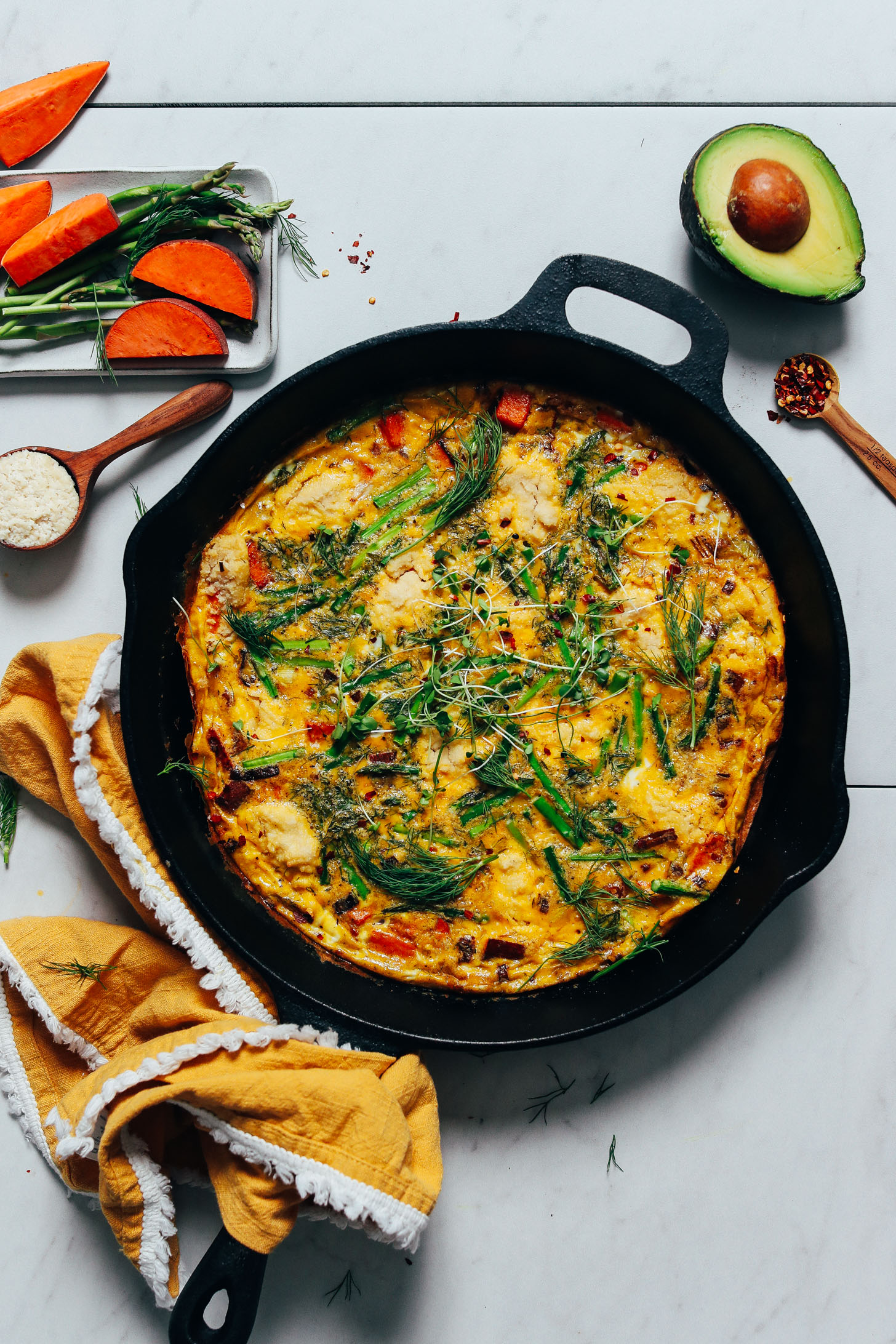 Cast iron skillet of our Spring Frittata made with Leeks, Asparagus, and Sweet Potato