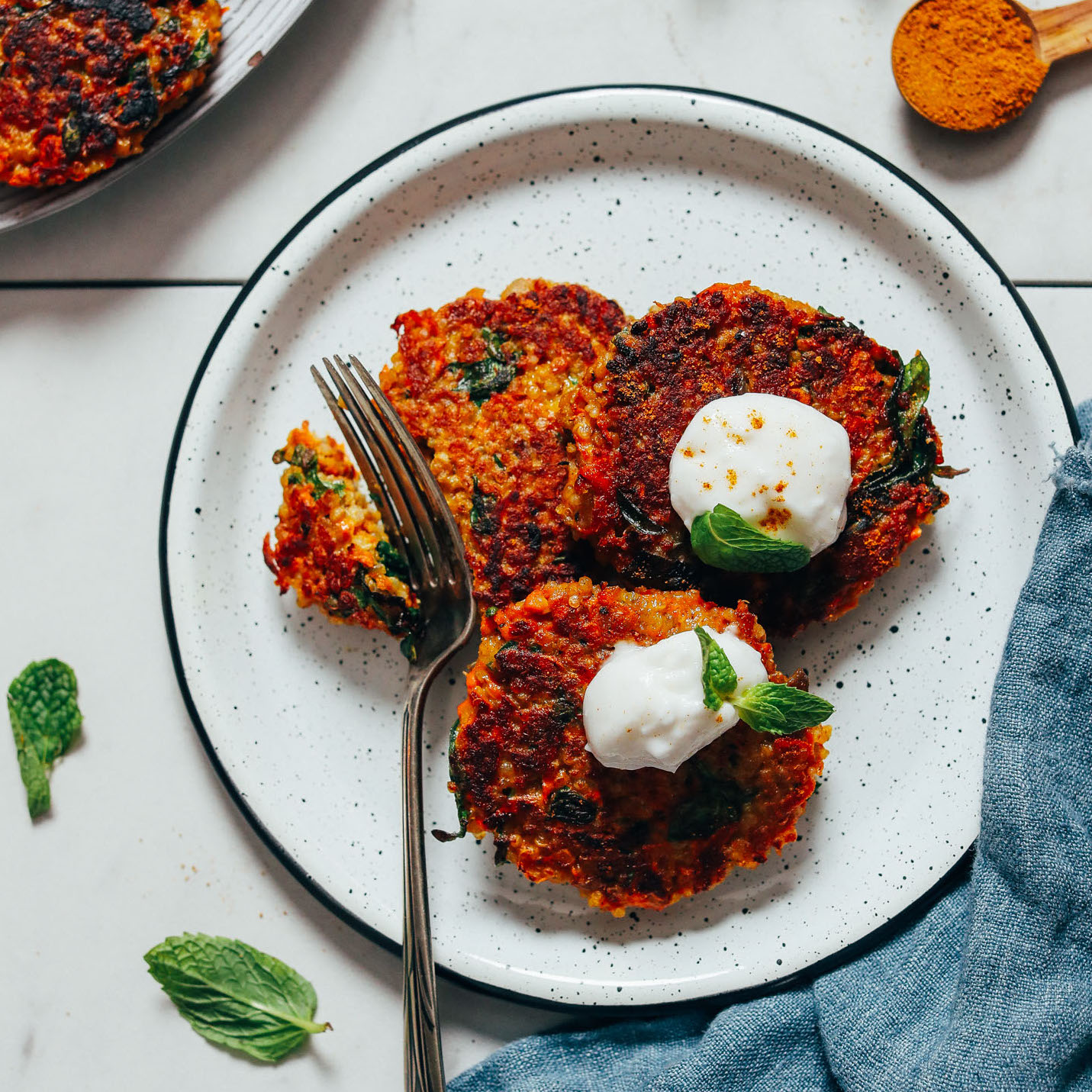 Slicing into Sweet Potato Quinoa Fritters on a plate