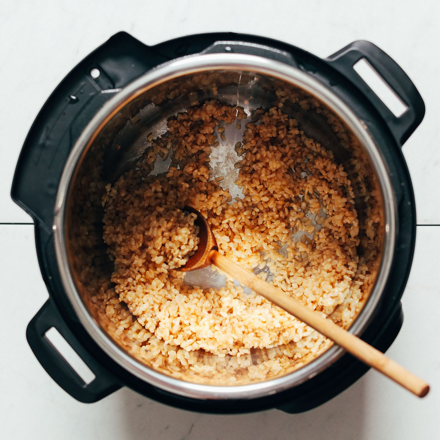 Instant pot filled with brown rice and water