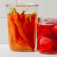 Jar of Quick Pickled Carrots and part of a jar of Quick Pickled Radish
