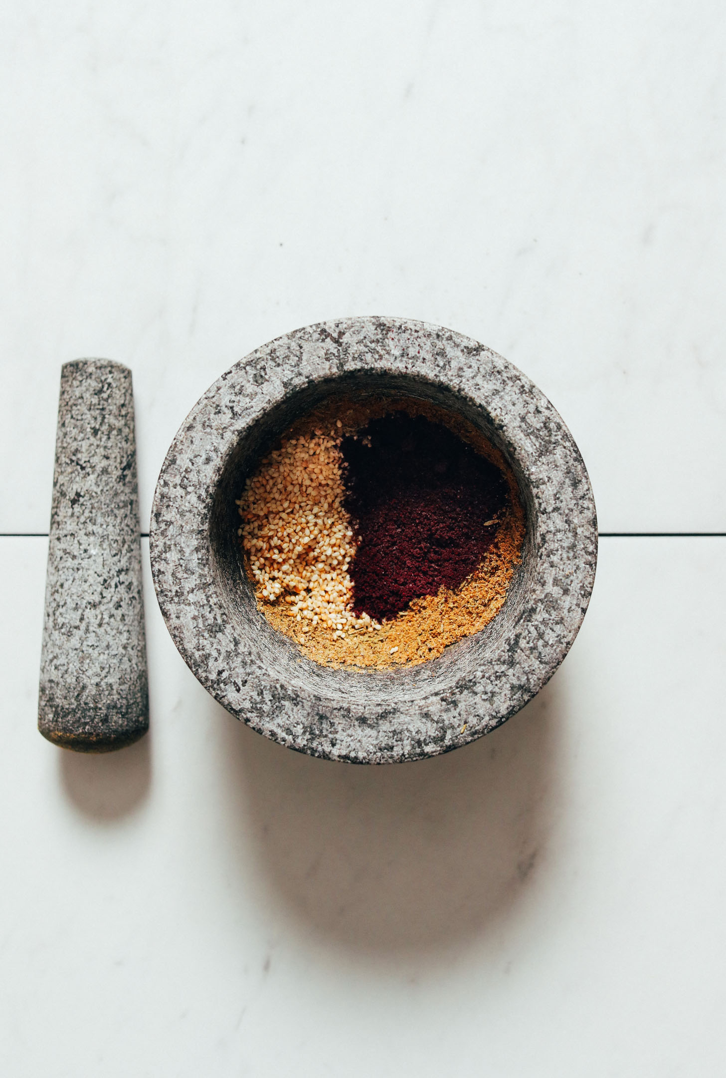 Mortar and pestle filled with ingredients for making za'atar
