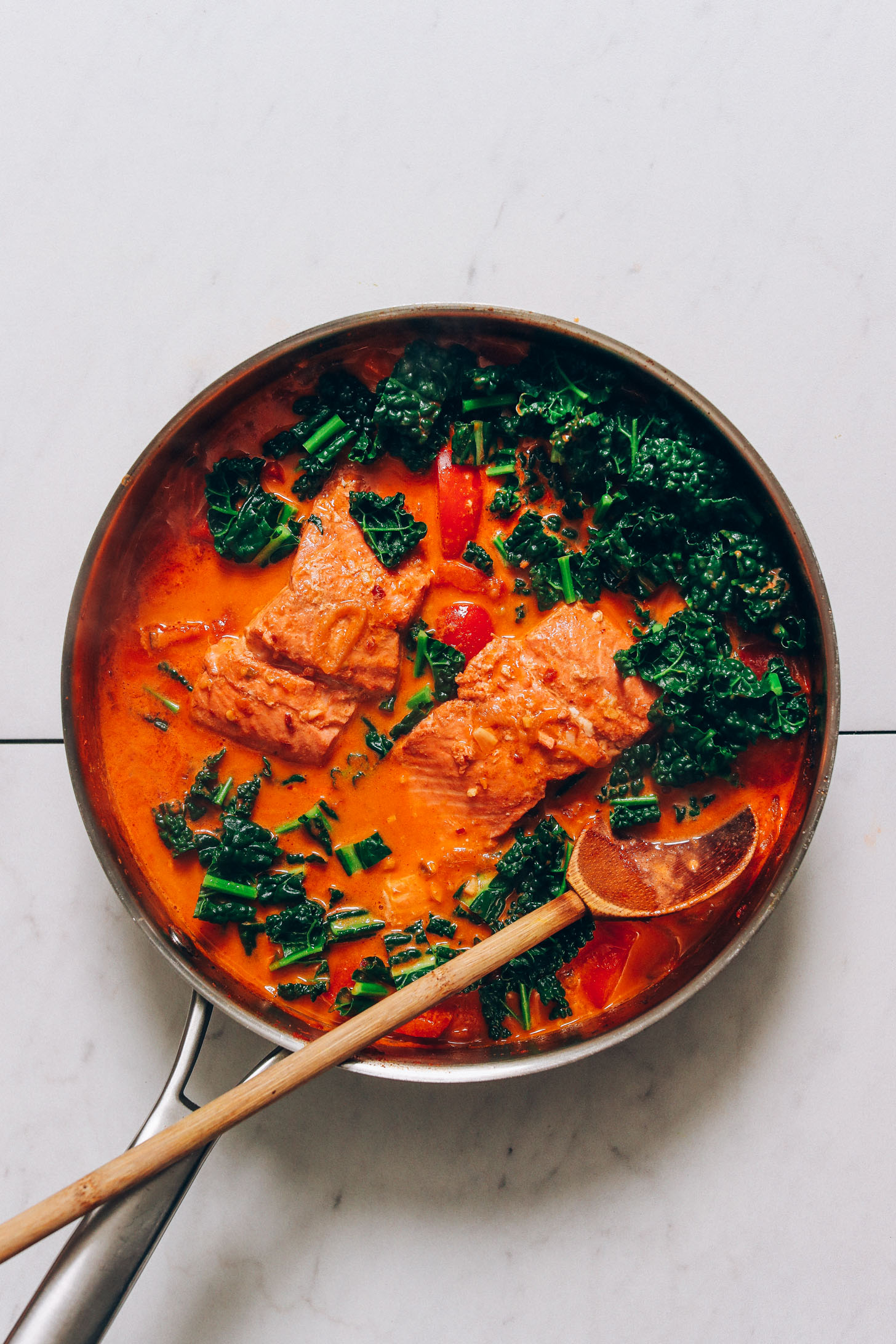Pan of our Salmon Red Curry recipe with chopped kale