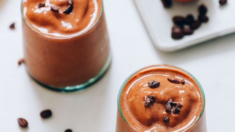 Small glasses of our Creamy Cold Brew Coffee Smoothie topped with cacao nibs