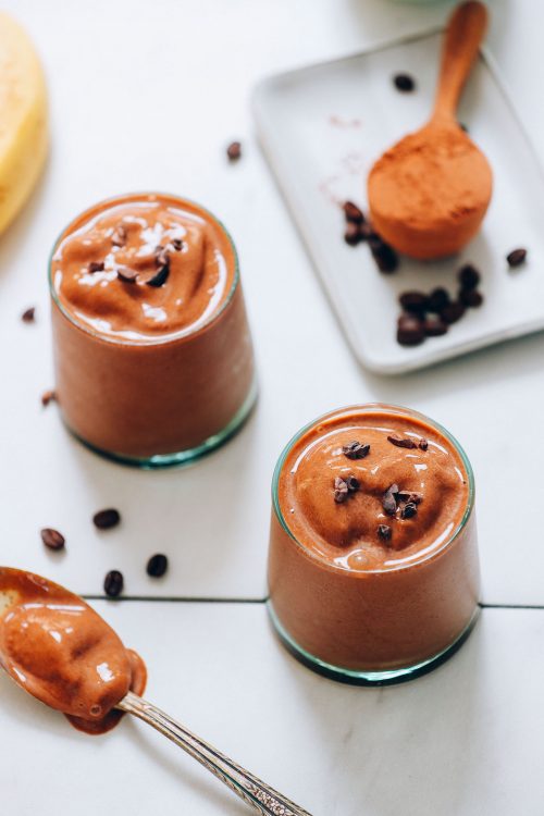 Small glasses of our Creamy Cold Brew Coffee Smoothie topped with cacao nibs