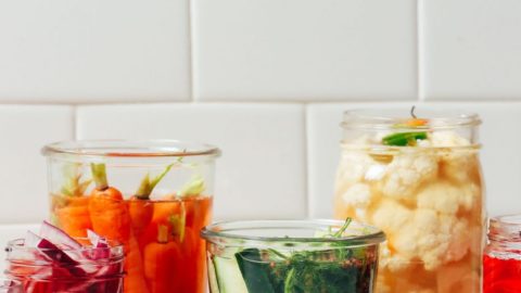 Jars of Quick Pickled Vegetables including, cucumbers, carrots, radishes, cauliflower, and onions