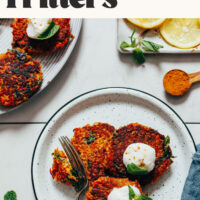 Plate of crispy quinoa sweet potato fritters topped with coconut yogurt