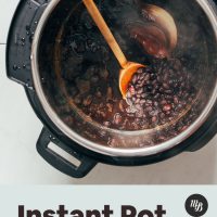 Wooden spoon in a pot of our Instant Pot Black Beans recipe