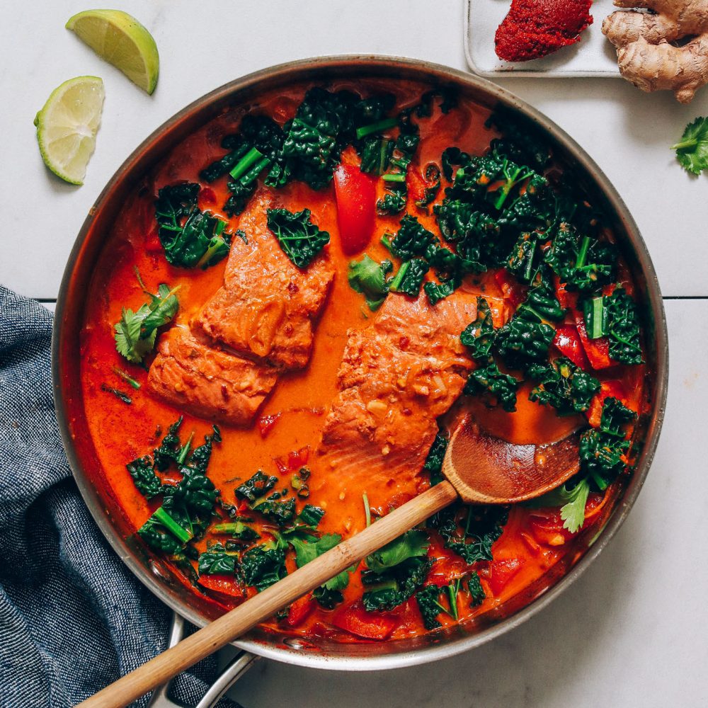 Skillet of Salmon Red Curry made with kale and coconut milk