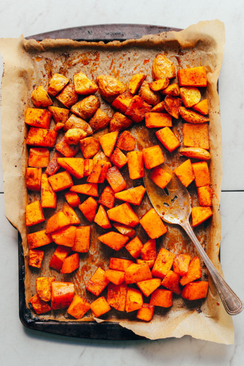 Parchment-lined baking sheet filled with freshly roasted butternut squash for our How to Make Roasted Vegetables recipe