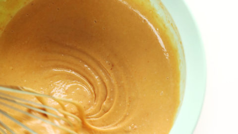 Whisking peanut sauce in a mixing bowl