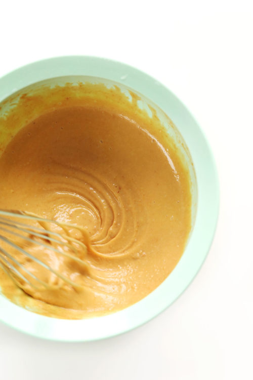 Whisking peanut sauce in a mixing bowl