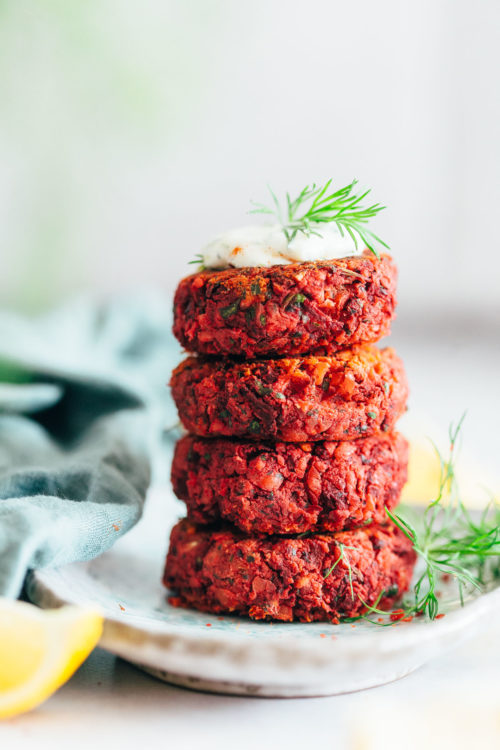 Stack of Easy Beet Falafel topped with dill and yogurt sauce