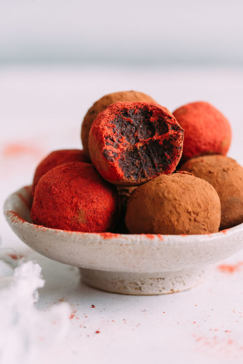 Bowl of No Bake Red Velvet Cake Balls coated in cacao powder and beet root powder