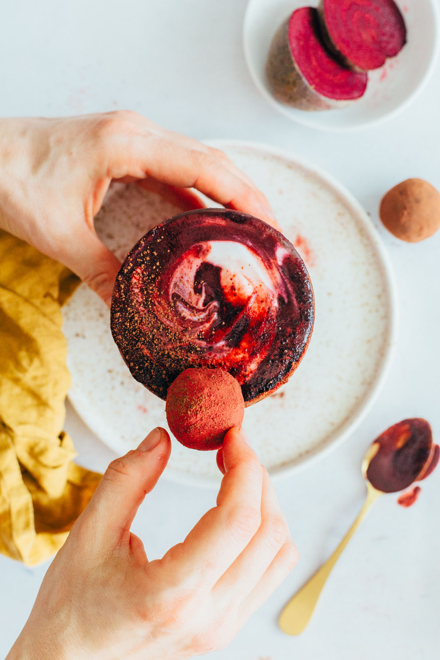 Placing a cake bite onto a red velvet smoothie