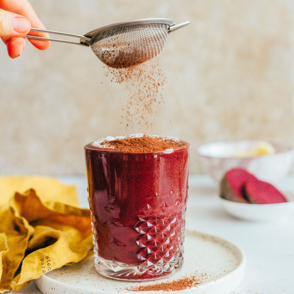 Dust a glass of our Red Velvet Cake Smoothie with cocoa powder