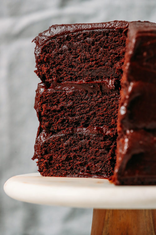 Triple layer Gluten-Free Vegan Chocolate Cake on a cake stand