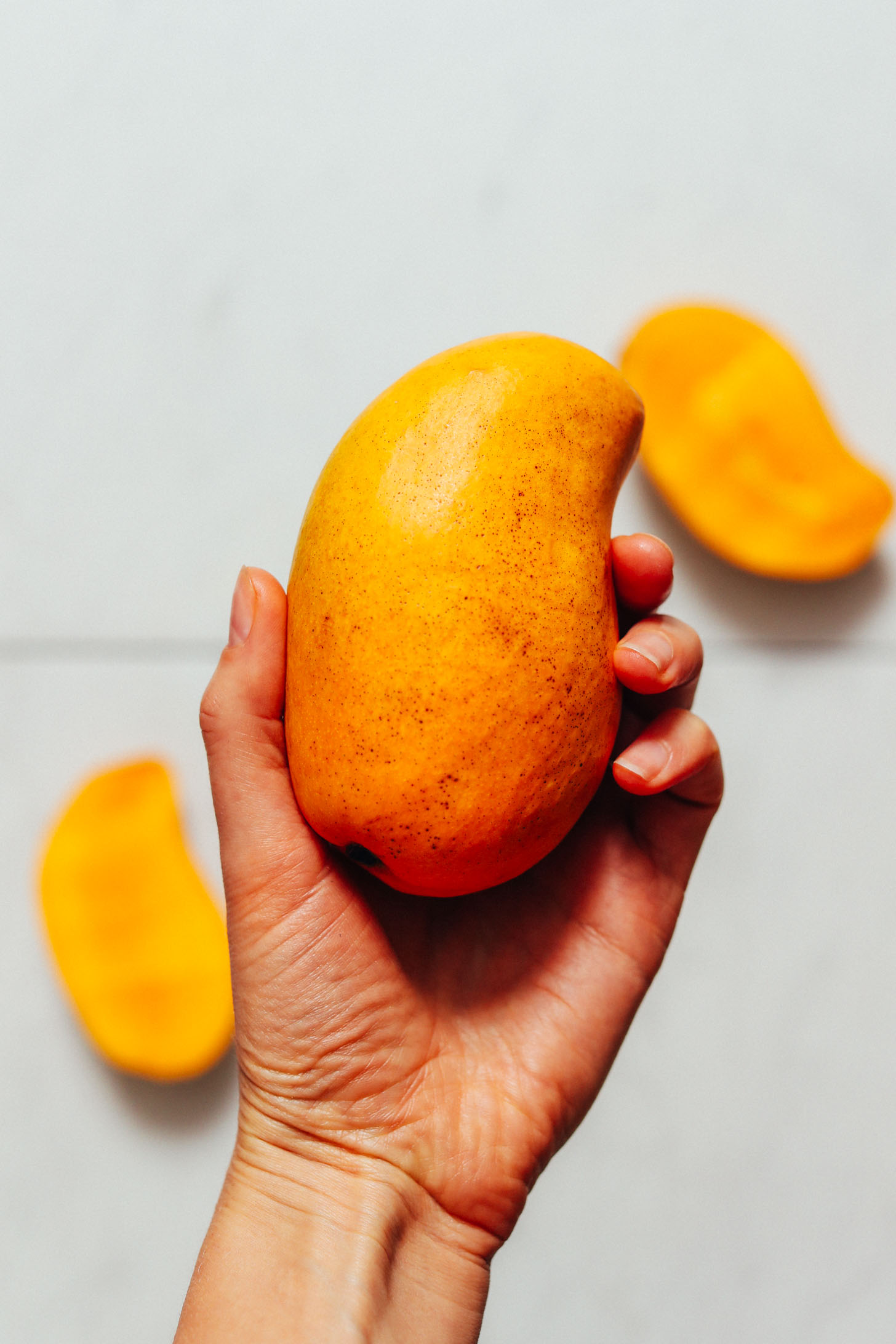 Holding a fresh mango