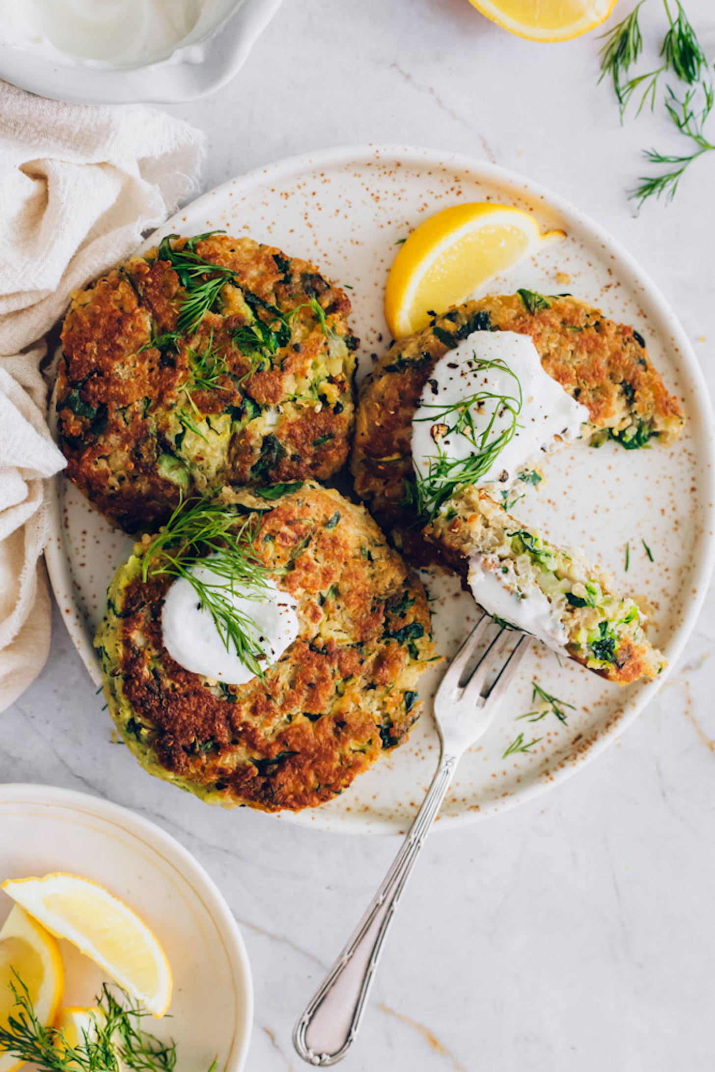 Plate of Dill Zucchini Fritters with lemon wedges