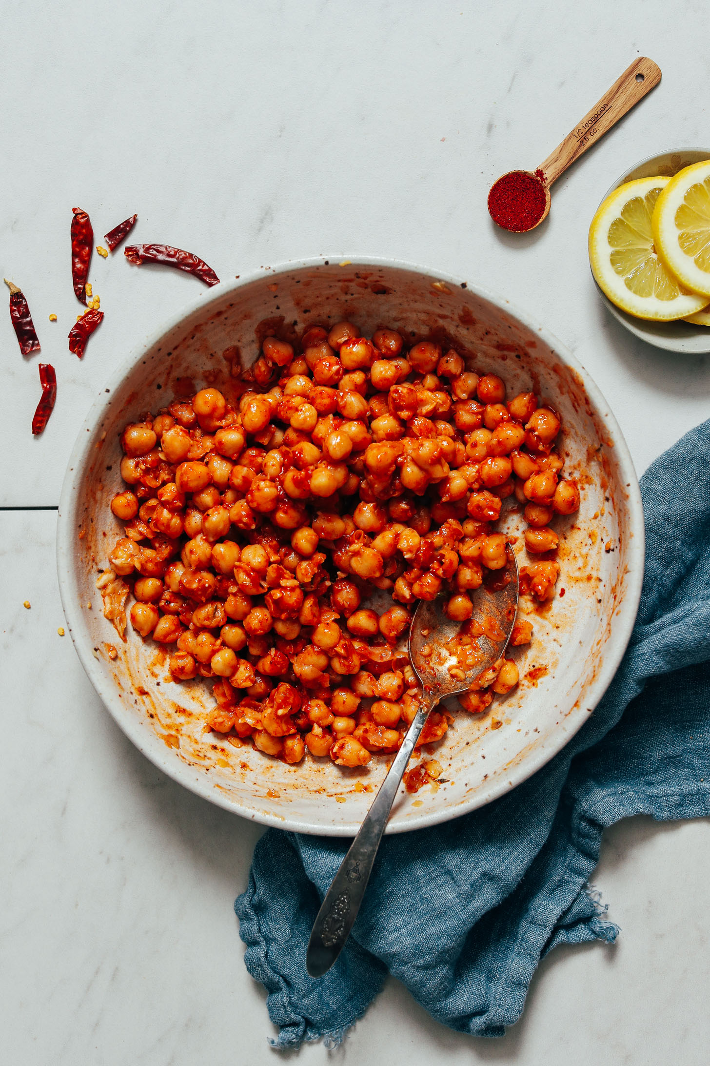 Spoon in a bowl of Harissa Marinated Chickpeas