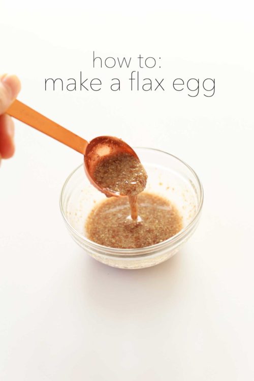 Flax egg dripping off a measuring spoon into a bowl