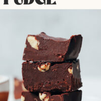 Stack of pieces of our easy dairy-free chocolate fudge studded with nuts