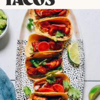 Platter of spicy baked fish tacos with text reading ready in 30 minutes