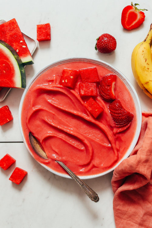Bowl of Watermelon Sorbet topped with chunks of watermelon and strawberries