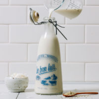 Pouring Coconut Hemp Milk from a measuring glass into a jug
