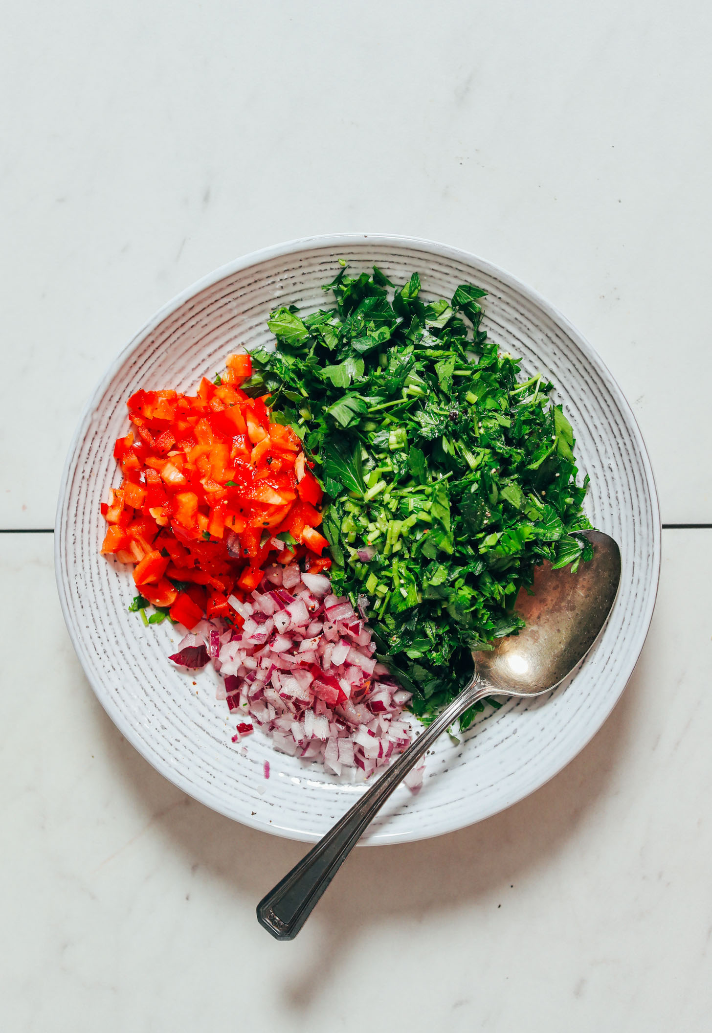 Bowl of parsley, bell pepper, and red onion