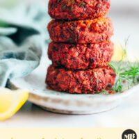 Stack of vegan beet falafel topped with dill sauce and fresh dill