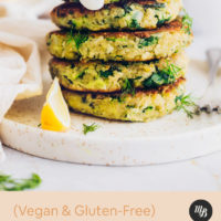 Stack of Vegan Zucchini Fritters topped with dairy-free yogurt and dill