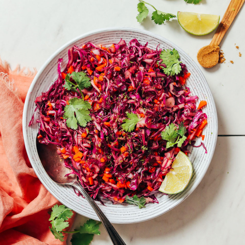 Vintage spoon in a bowl of mayo-free Citrusy Cabbage Slaw