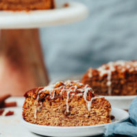 Cake stand and plate with slices of vegan gluten-free coffee cake